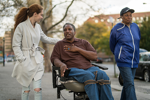 Man in wheelchair with caregiver